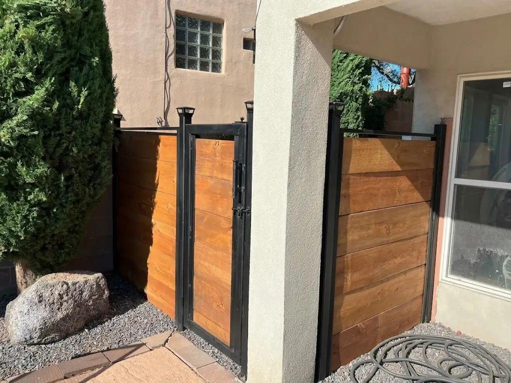 Steel-frame fence and gate with horizontal stained wood panels
